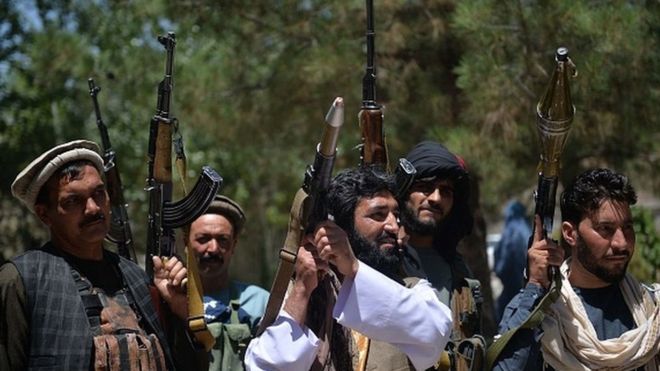 People gather with their heavy weapons to support Afghanistan security forces against the Taliban
