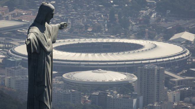 The Christ the Redeemer statue stands above Maracana stadium in Rio de Janeiro