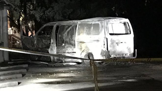The burnt out van cordoned off by police tape