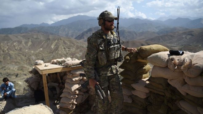 In this photo taken on July 7, 2018, a US Army soldier from Nato and an Afghan Local Police (ALP) look on in a checkpoint