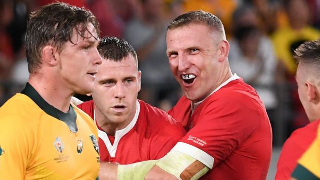 Australia captain Michael Hooper looks dejected as Wales try-scorers Gareth Davies and Hadleigh Parkes celebrate