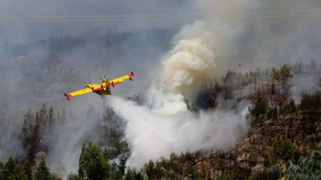 A Spanish Canadair fire fighting aircraft drops water over the Pedrogao Grande forest fire, in central Portugal, 18 June 2017.