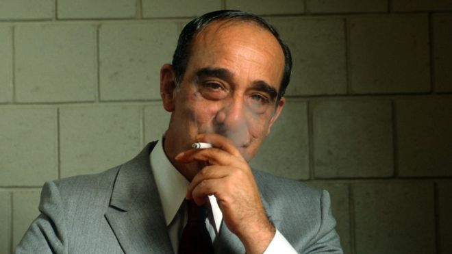 Carmine Persico, smiling and smoking