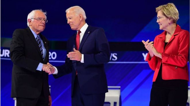 Democratic presidential hopefuls US Senator for Vermont Bernie Sanders (R) greets Former US Vice President Joseph R. Biden Jr. (L) as Massachusetts Senator Elizabeth Warren looks on during the third Democratic primary debate