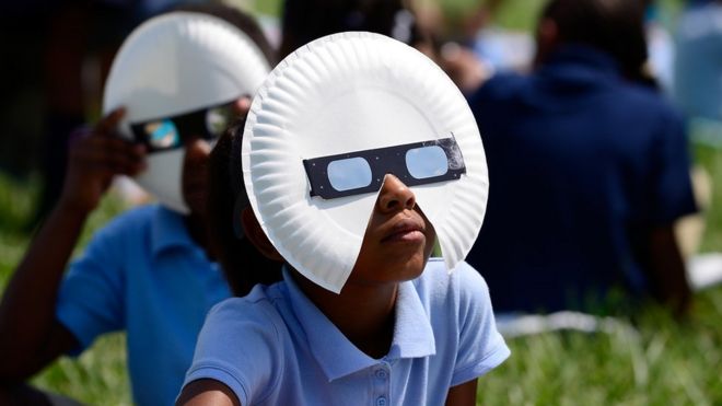 Students at the Jennings School District view the solar eclipse with glasses donated by Mastercard on August 21, 2017 in St Louis, Missouri.