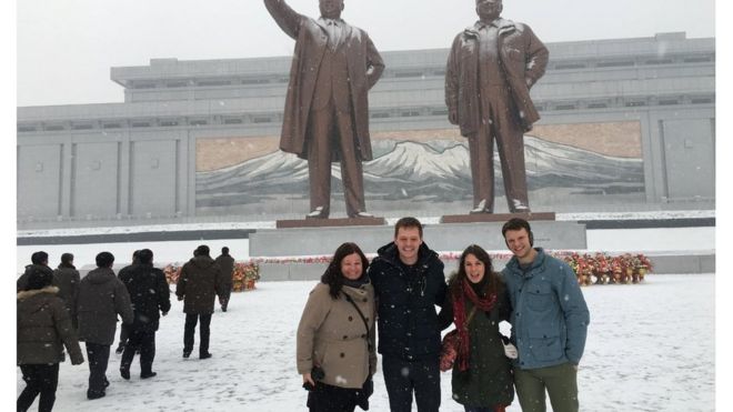 Otto Warmbier and friends pose in front of statues in North Korea
