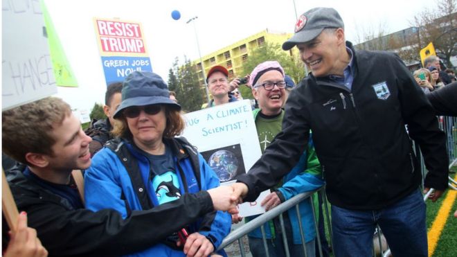 Washington state Governor Jay Inslee shakes hands with people in the crowd after speaking at a rally during the March for Science at Cal Anderson Park on April 22, 2017 in Seattle, Washington.