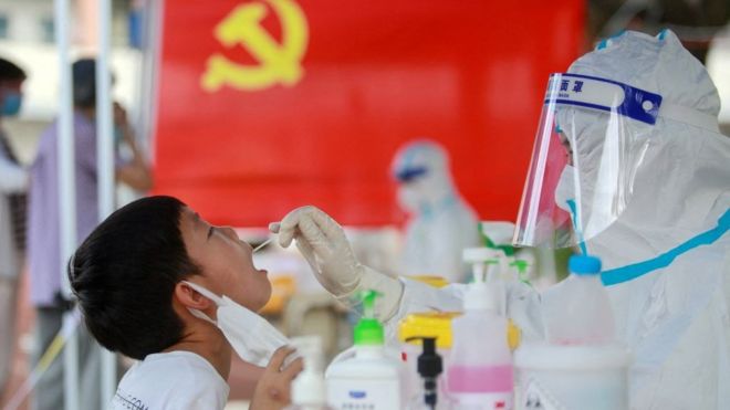 A child receives a nucleic acid test for the Covid-19 coronavirus in Yangzhou, in China's eastern Jiangsu province on 5 August 2021.