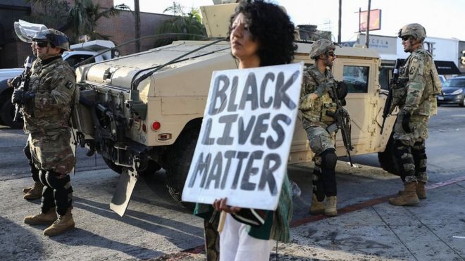 Protester next to National Guard unit in Los Angeles, 31 May 20