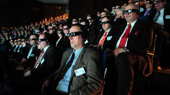 An audience watches a 3D movie