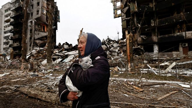 An old lady with a cat in a war zone in Ukraine