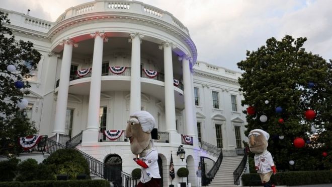 The mascots of the Washington Nationals baseball team called "The Racing Presidents" run in front of the White House during a celebration of Independence Day in Washington, U.S., July 4, 2021