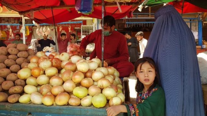 Afghans shop for food in a Kabul bazaar.