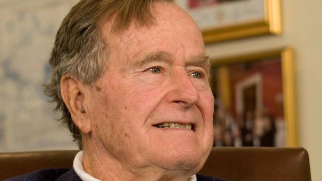 Former President George H.W. Bush smiles as he listens to Republican presidential candidate Mitt Romney speak as he met with Bush to pick up his formal endorsement in Houston March 29, 2012