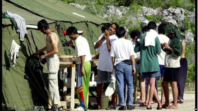 Мужчины бреются, чистят зубы и готовятся к дню в лагере беженцев на острове Науру, в пятницу, 21 сентября 2001 года. В течение трех дней прибыло множество людей, ищущих убежища, после того как более 500 человек было отказано во въезде в Австралию ,