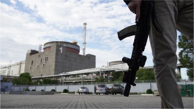 A security guard stands in front of the Zaporizhzhia nuclear plant on 11 September