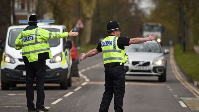 Police officers from North Yorkshire Police stop motorists in cars to check that their travel is 