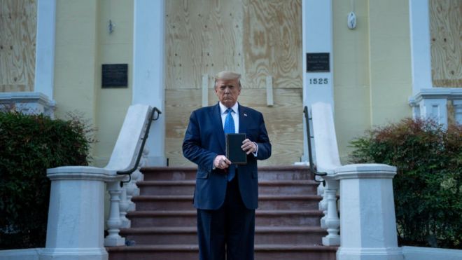 Trump holds a Bible that was carried from the White House by his daughter Ivanka
