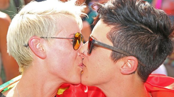 Two women kiss at a celebration in Melbourne