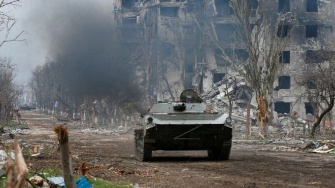 Pro-Russian troops ride an armoured vehicle during fighting in Ukraine-Russia conflict near a plant of Azovstal Iron and Steel Works company in the southern port city of Mariupol, Ukraine April 12, 2022