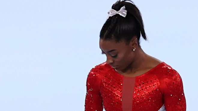 Simone Biles lookes down in disappointment