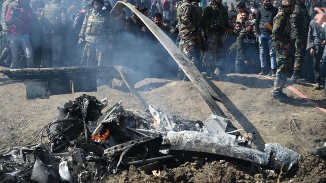 Indian soldiers near the remains of an alleged Indian Air Force aircraft after it crashed in Budgam district, some 30 kms from Srinagar on February 27, 2019.