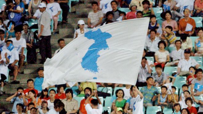 South Korean supporters wave "reunification" flags for the North Korean football team during a match between South and North Korea at the East Asian Football Championship in Jeonju, Seoul, 4 August 2005