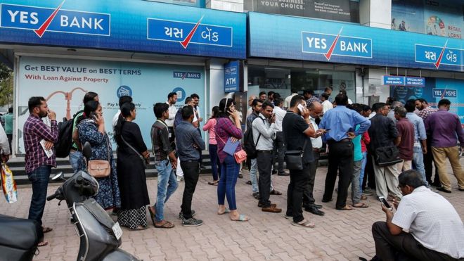 Queue of people outside a branch of Yes Bank