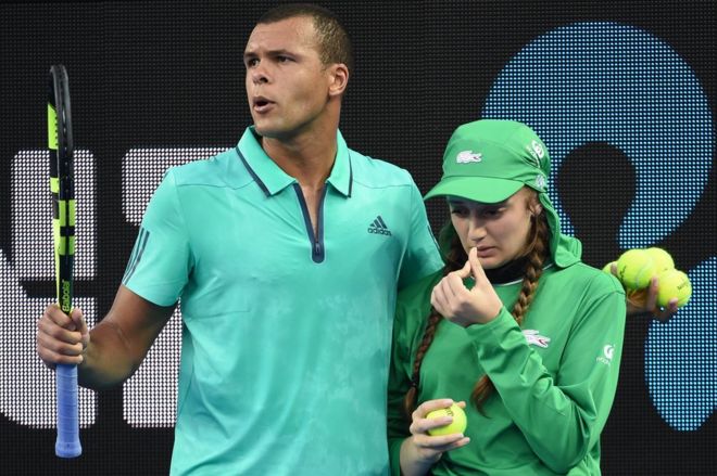 Jo-Wilfried Tsonga escorts ball girl Guiliana off court at last year's Australian Open