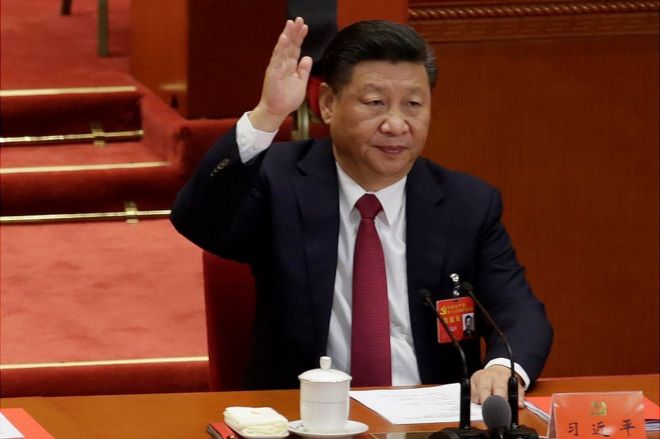 Chinese President Xi Jinping raises his hand as he takes a vote at the closing session of the 19th National Congress of the Communist Party of China at the Great Hall of the People, in Beijing, China 24 October 2017.