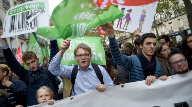 Protesters wave flags at the protest in Paris