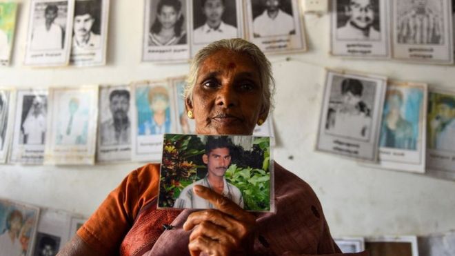 Sri Lankan Tamil woman holds a picture of a missing loved, Missing people organization office