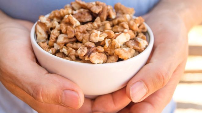 Man with bowl of walnuts