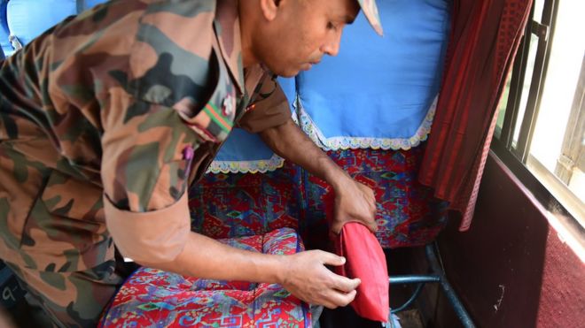 A Bangladesh Border Guard (BGB) finds drugs on a passenger bus during a search at a checkpoint, 6 April 2018