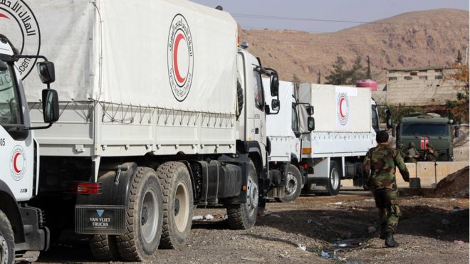 Trucks belonging to the International Committee of the Red Cross (ICRC) are parked on the outskirts of rebel-held Eastern Ghouta, 8 March 2018