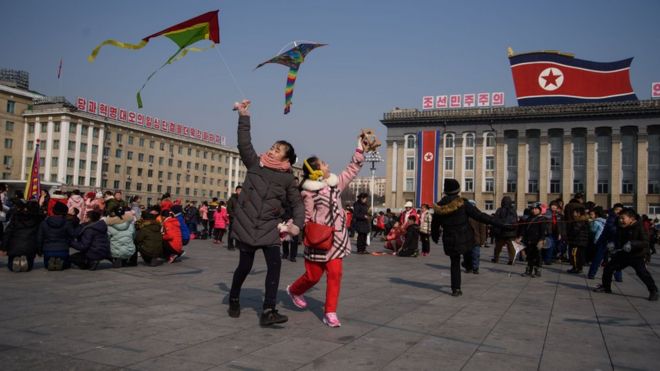 Children fly kites during Lunar New Year festivities on Kim Il Sung square in Pyongyang on February 16, 2018