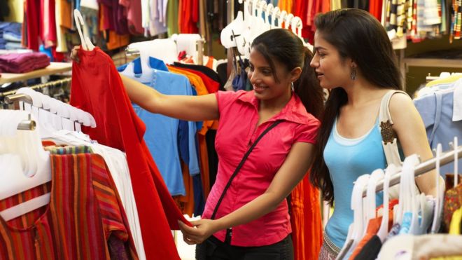 Mulheres vendo roupa em loja