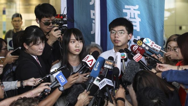 Agnes Chow (L) and Joshua Wong after being released on bail 30 Aug