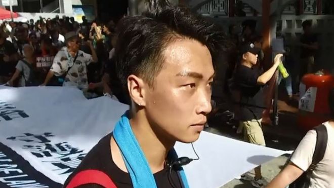 Jimmy Sham carrying a banner at a Hong Kong protest march