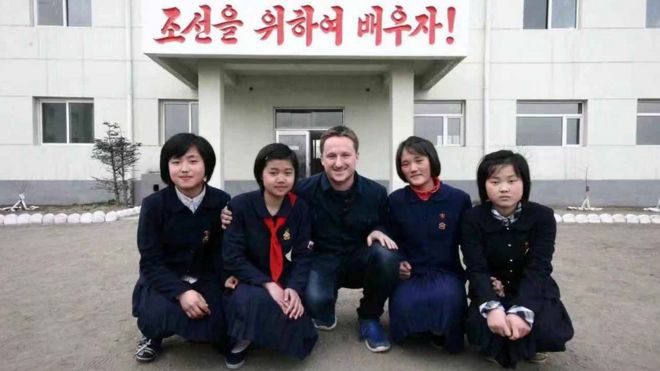 Canadian businessman Michael Spavor poses with girls at a school in Rason Special Economic Zone, North Korea