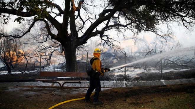 Пожарный борется с Пиковым огнем в Сими-Вэлли, Калифорния, 12 ноября