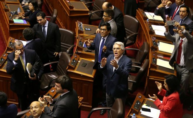 Lawmakers supporting President Pedro Pablo Kuczynski celebrate after Kuczynski defeated an opposition bid to force him from power in Congress in Lima, Peru, December 21, 2017