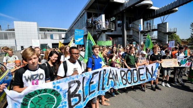 Молодые люди принимают участие в демонстрации действий по борьбе с изменением климата «Пятница для будущего» в международном аэропорту Дюссельдорфа