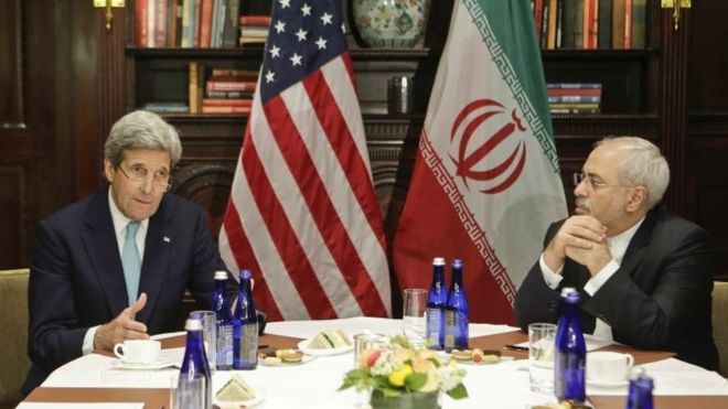 Secretary of State John Kerry speaks to the media as Iranian Foreign Minister Mohammad Javad Zarif listens in New York.