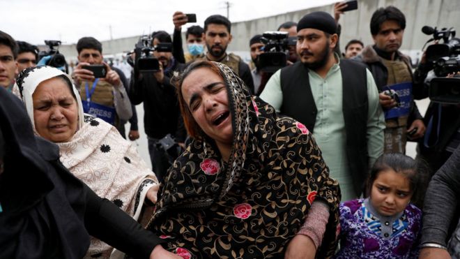 An Afghan Sikh woman grieves for her relatives near the site of an attack in Kabul, Afghanistan March 25, 2020