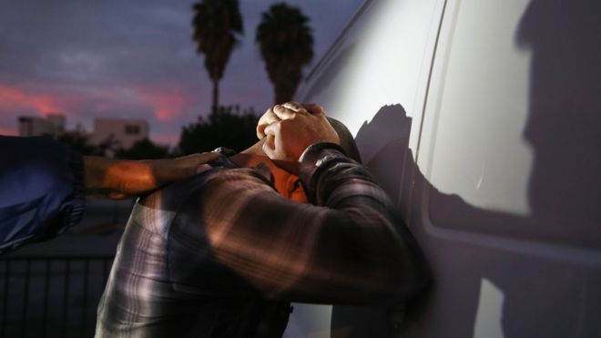 A man is detained by Immigration and Customs Enforcement (ICE), agents early on October 14, 2015 in Los Angeles, California.