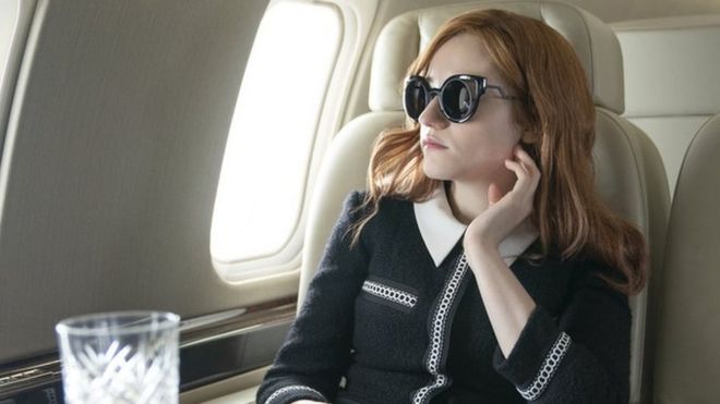 Julia Garner in a private jet playing Anna Sorokin in the Netflix series Inventing Anna
