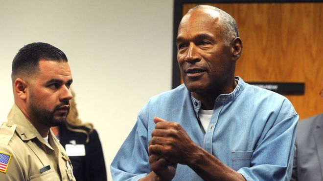 OJ Simpson (L) reacts after being granted parole at Lovelock Correctional Centre in Lovelock