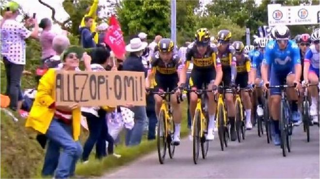 The spectator can be seen holding a sign