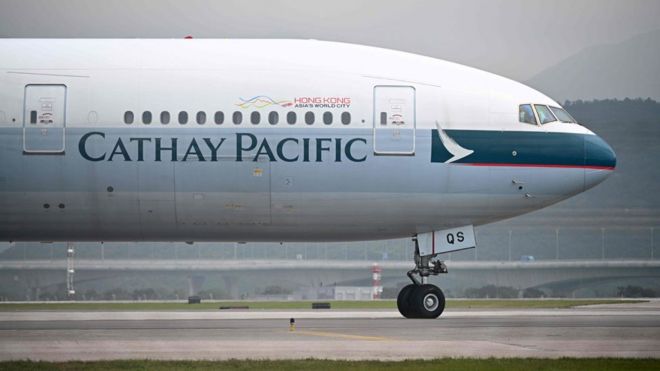 A Cathay Pacific plane lands on the tarmac